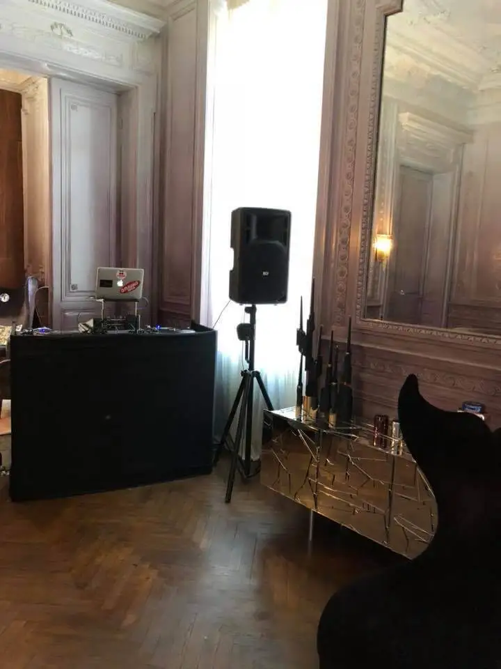 Régie DJ et enceinte installées dans un salon de château au parquet ancien